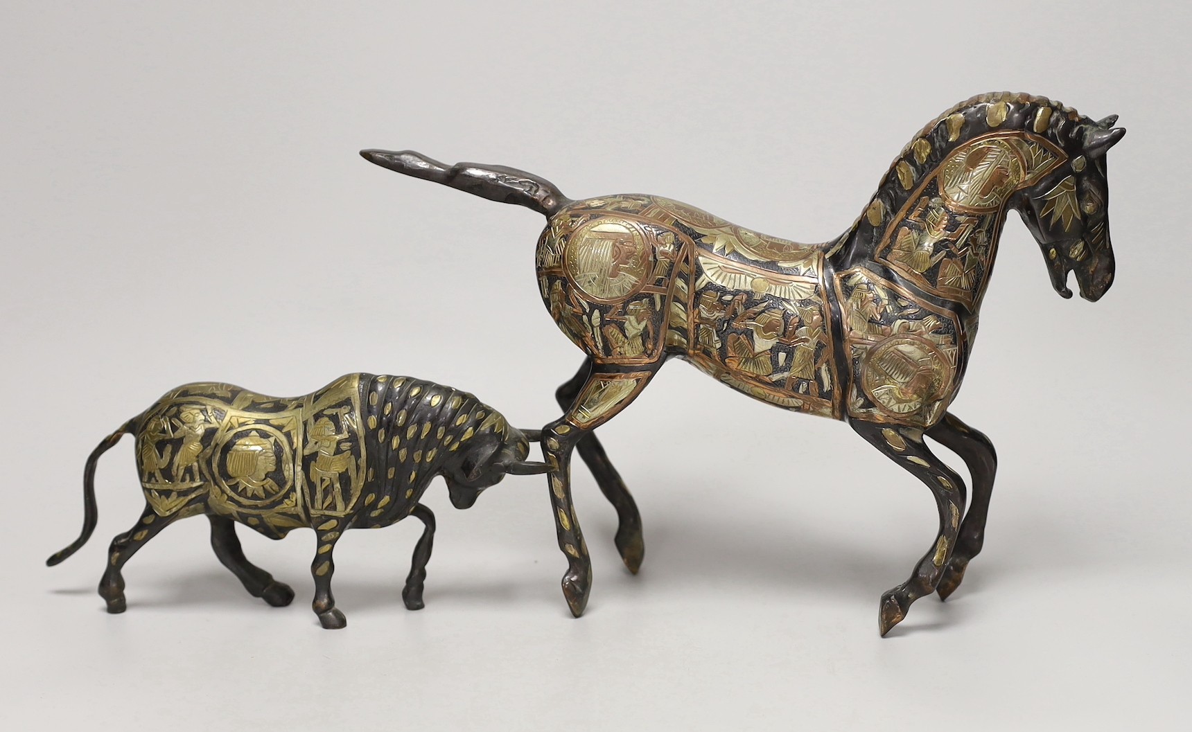 Two Egyptian cast brass and mixed metal models of a bull and a horse. Tallest 23cm